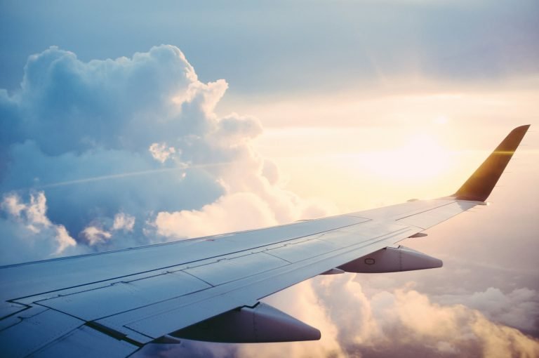 An aeroplane wing above the clouds